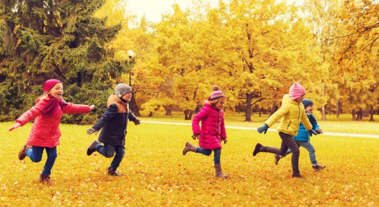 group of happy little kids running outdoors